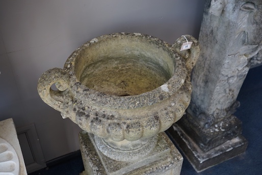 A pair of reconstituted stone campana garden urns on stands, diameter 60cm, height 82cm